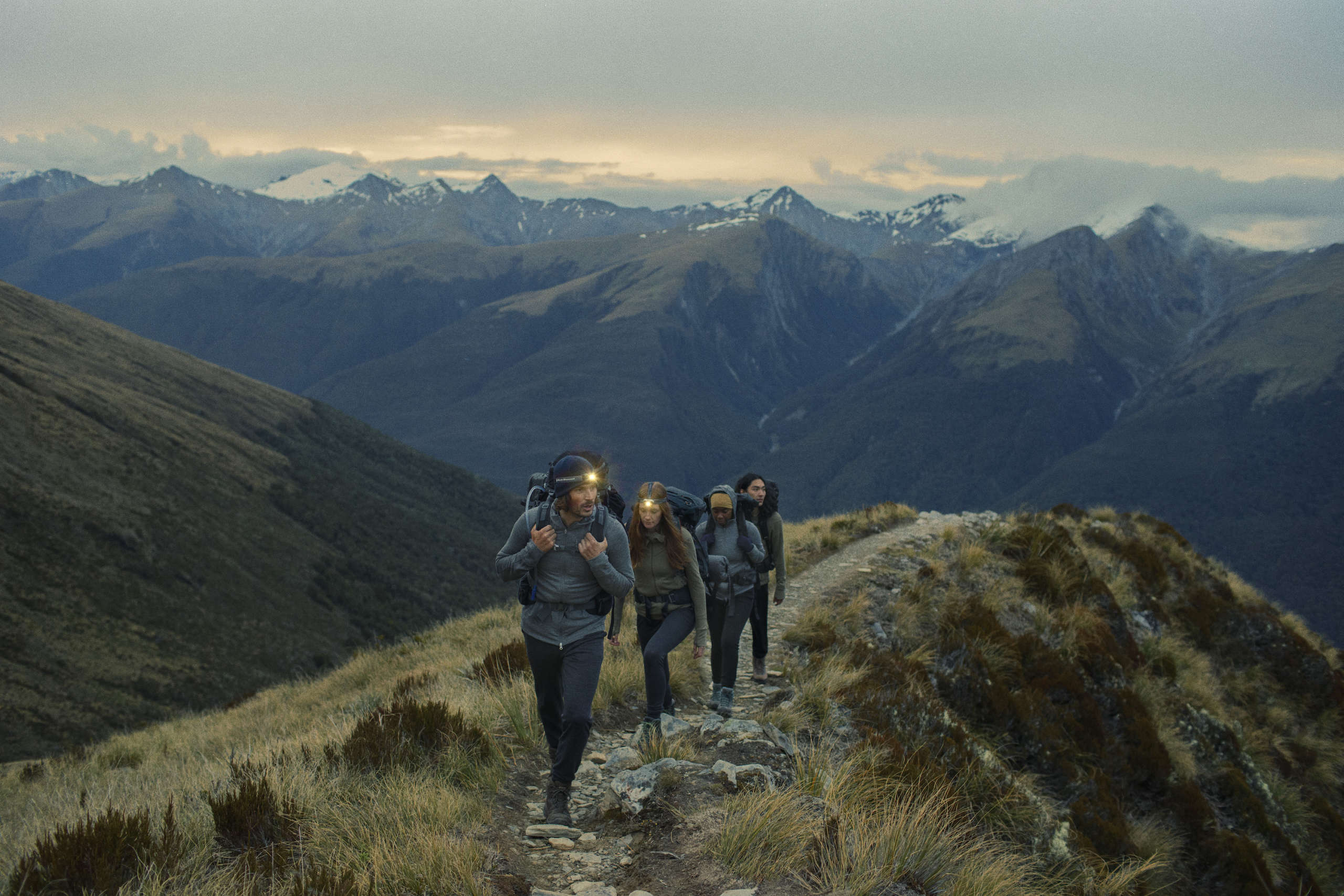 Icebreaker customers wearing outdoor gear on a mountain