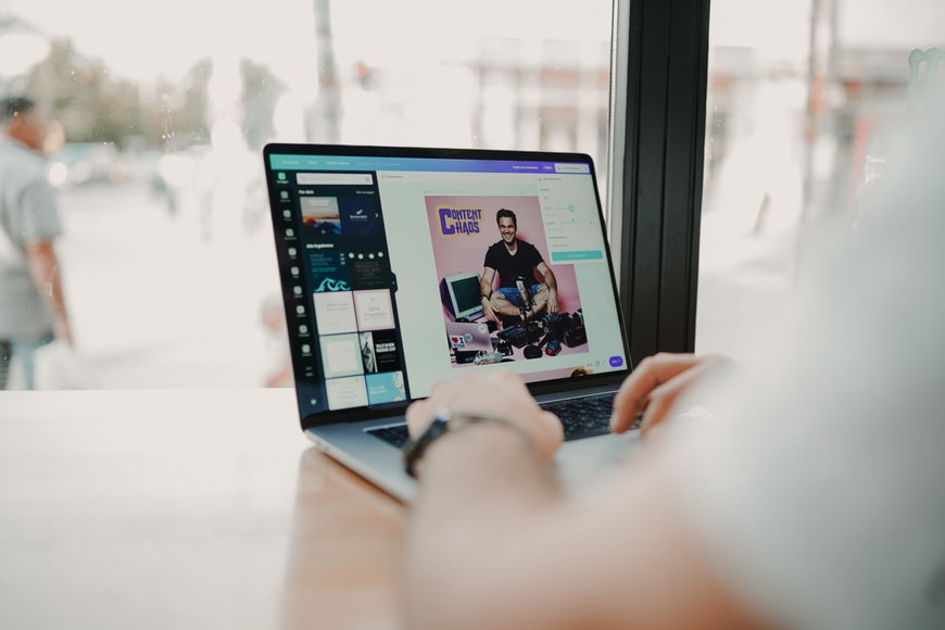 people working on canva with laptop